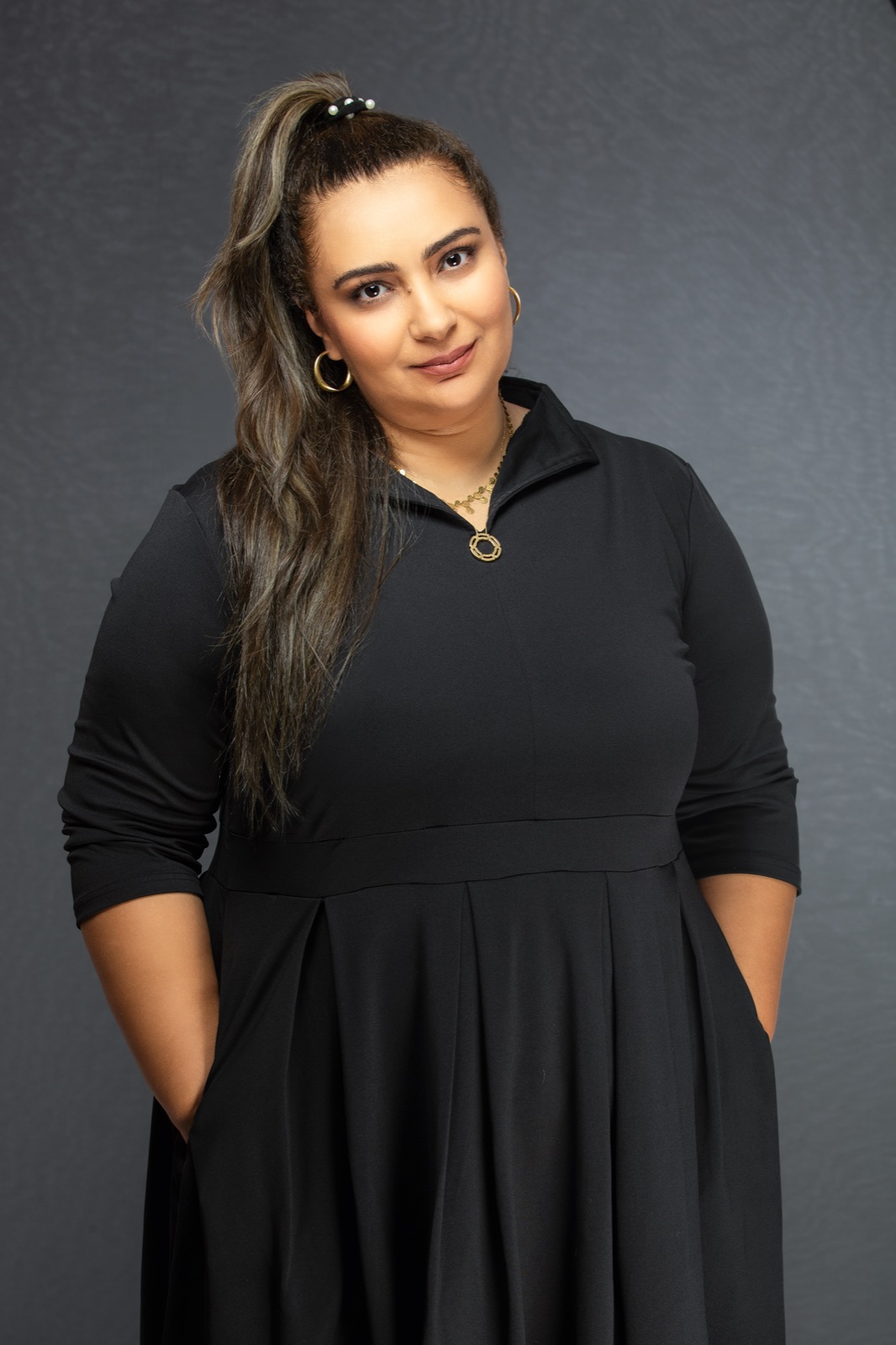 Studio portrait of Nahla ElBanhawy in a black dress against a grey ground