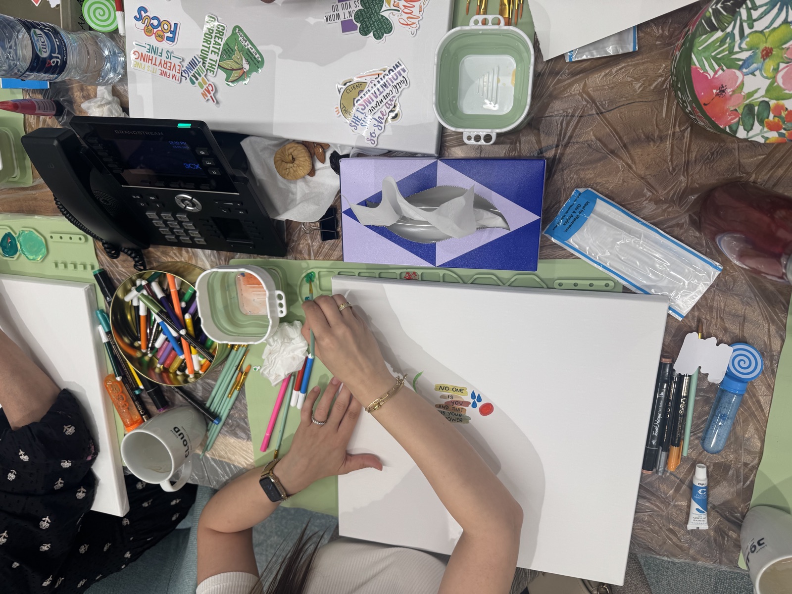 A collage in progress — cut shapes, paint and pens across a worked sheet